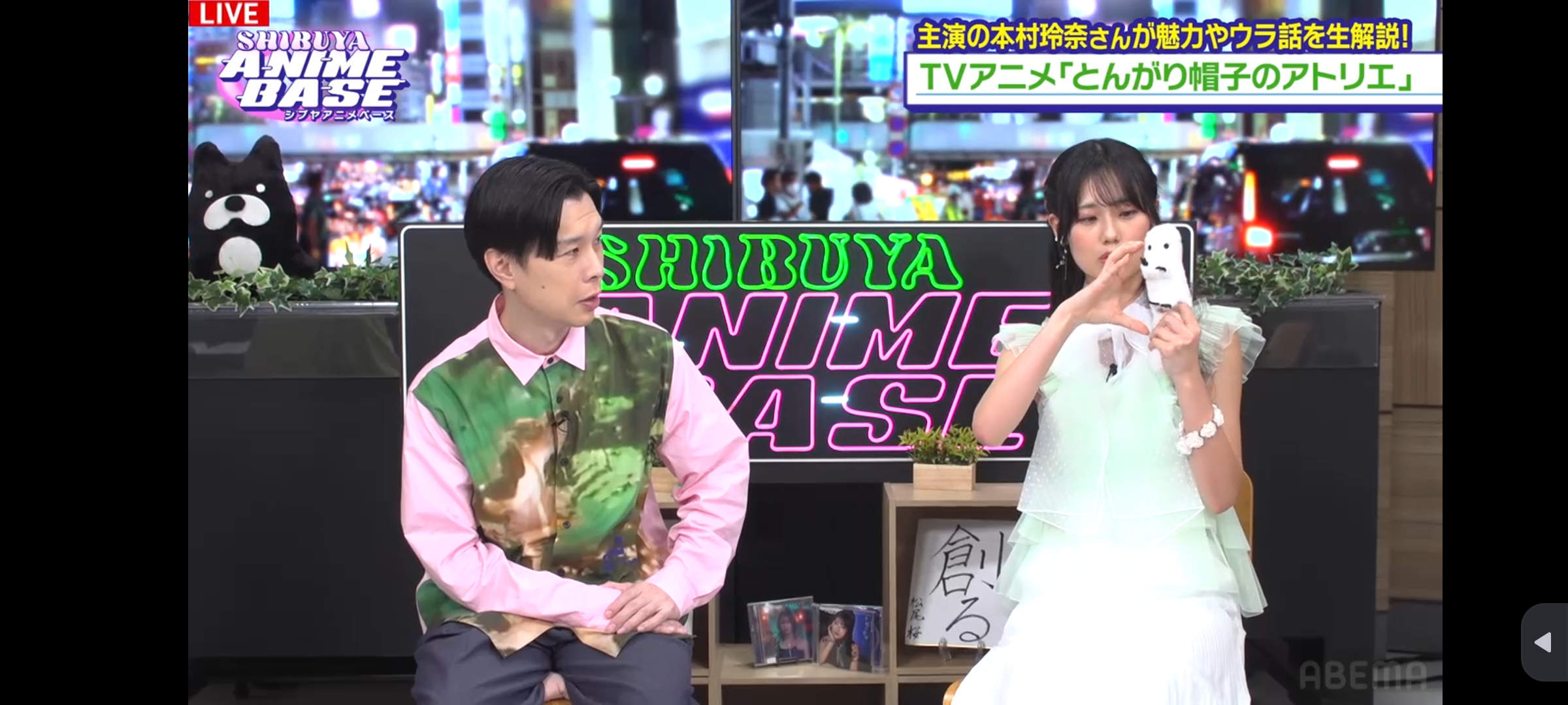 Witch hat atelier voice actor rena motomura demonstrating the thickness of the storyboards by using a hand widening gesture